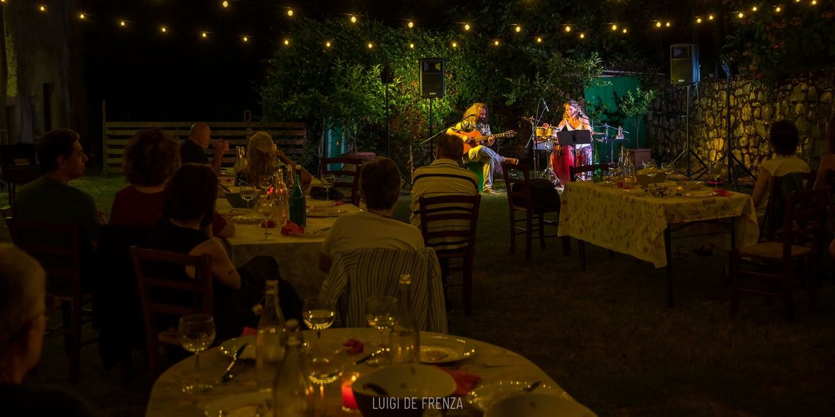 Afro Samba Duo performing for a seated audience outdoors