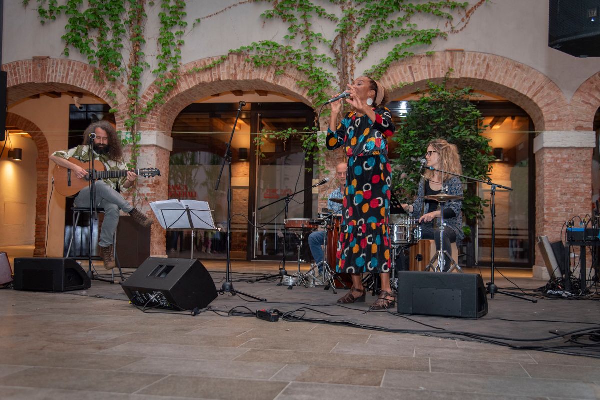 AfroAmerIndios performing in a courtyard