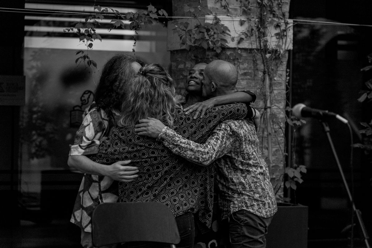 Musicians embracing on stage