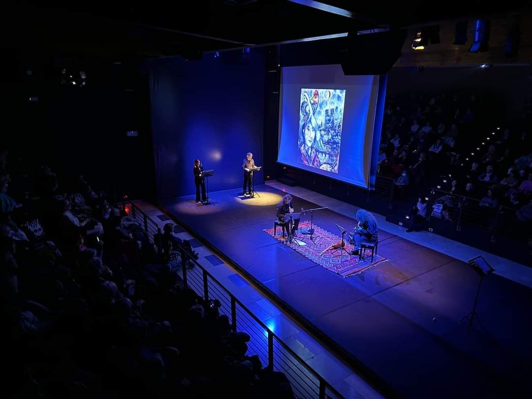 Balkalà on a blue-lit stage