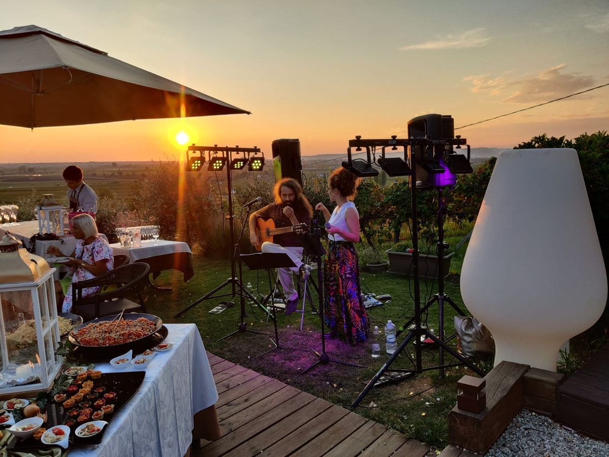 Blu Papillon performing outdoors at sunset