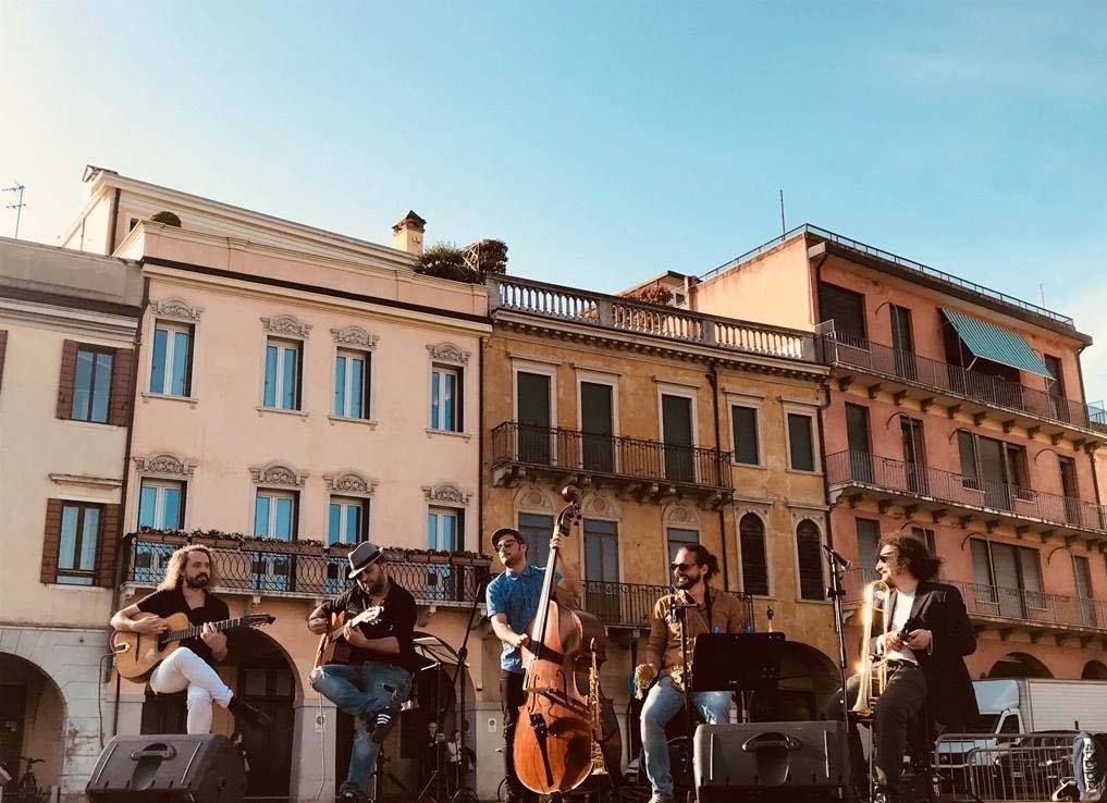 Joe Stray performing outdoors in a town square