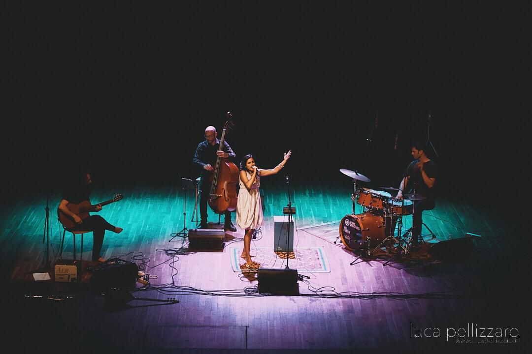 Mi Linda Dama performing on a dark stage