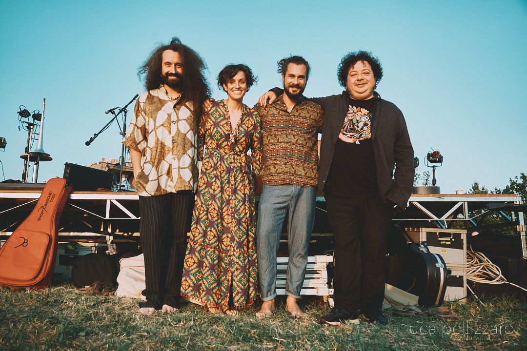 Four musicians outdoors after a performance